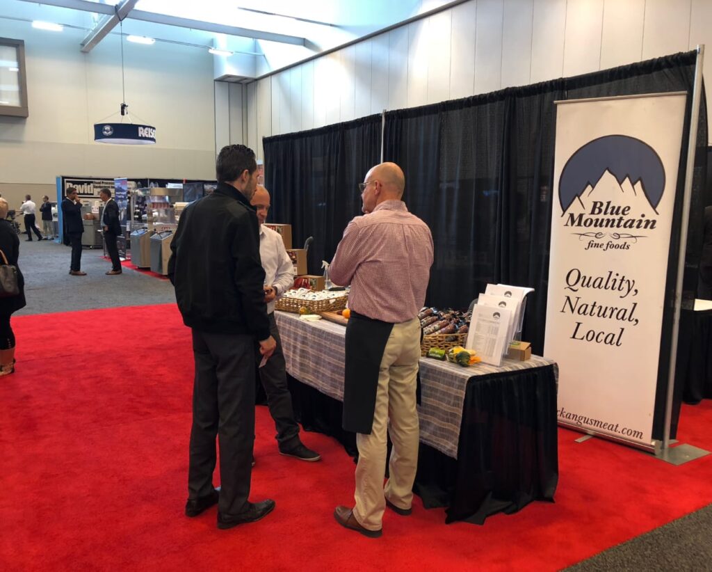 people chatting at a booth